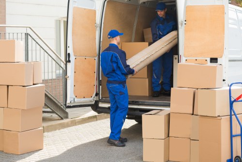 Local house removals team preparing furniture for moving day in Removalservices