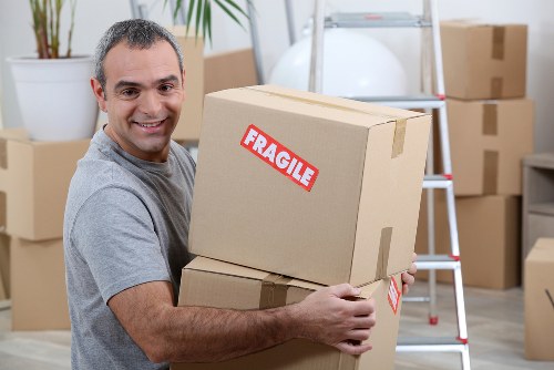 Removal team collecting a sofa from a local home