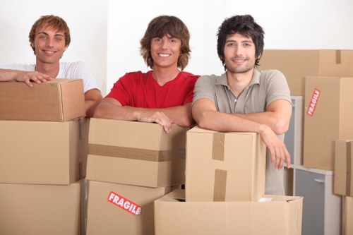 Removal team loading boxes and furniture into a truck