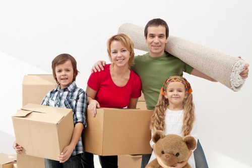 Moving crew handling boxes and furniture for a home relocation