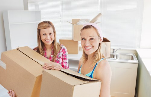 Team handling apartment access and furniture protection during a move